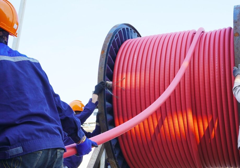 Workers Using a Cable Drum Roller